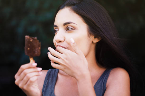 istock Beautiful woman eating ice-cream 1170331180