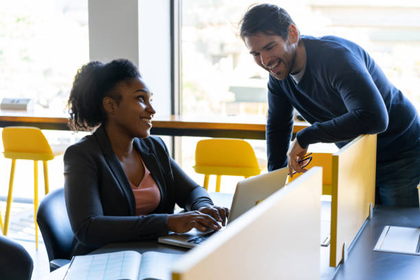 istock Office diverse coworkers discussing something funny while looking at laptop screen 1170332183