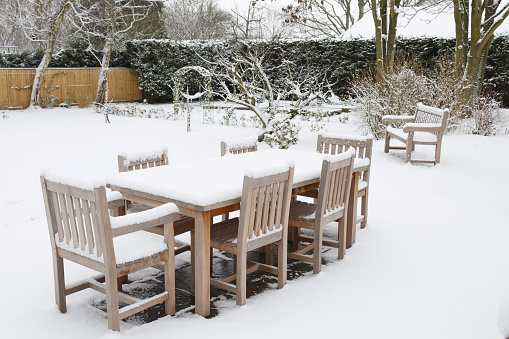 Patio garden furniture covered with snow in winter, UK