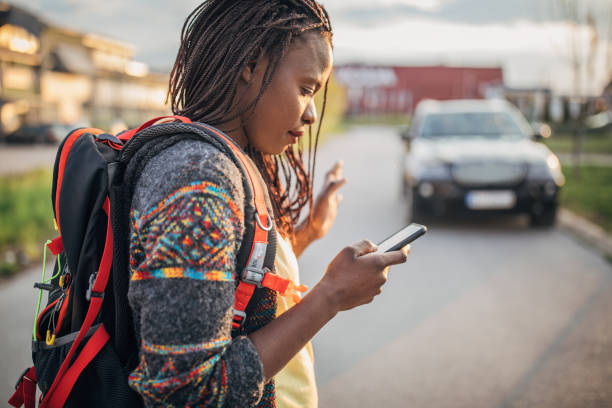 istock African-American woman with backpack text messaging 1170332307