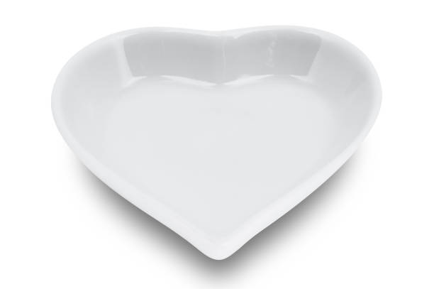 istock White plate in shape of heart isolated on white background. 1170332563
