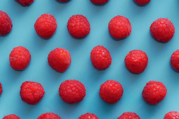 istock View from above of red raspberries over a blue plate 1170334146