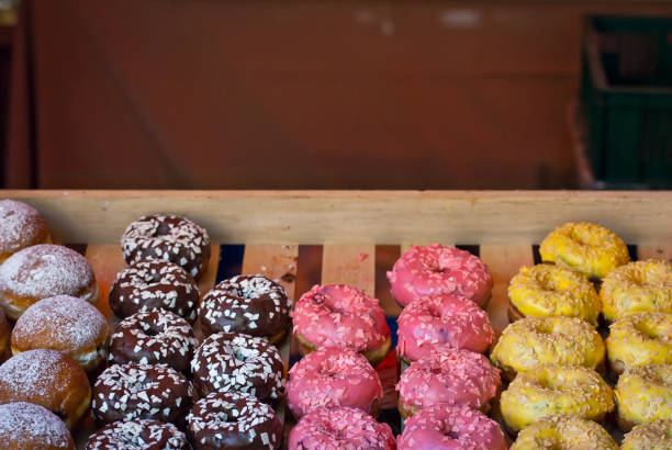 istock Multicolored round sweets at the shop window. Many cakes on a shelf. 1170335225