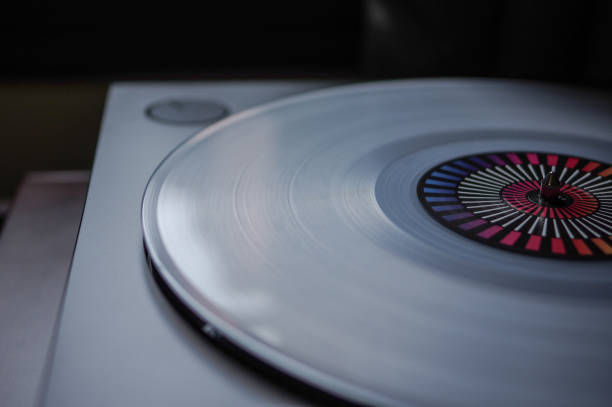 istock Transparent white clear vinyl record disc with rainbow colored label on modern belt drive turntable 1170336021