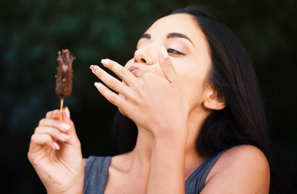 istock Beautiful woman eating ice-cream 1170338561