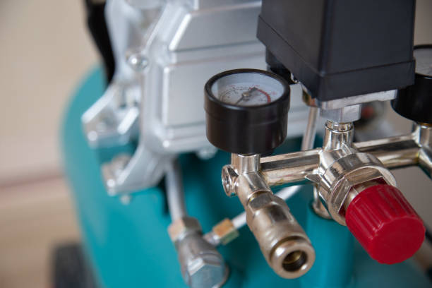 Air compressor pressure pump closeup photo with selective focus on an emergency shutdown valve. Tools series Gas Powered Air Compressor stock pictures, royalty-free photos & images