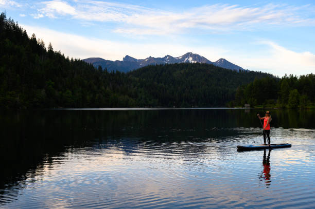 istock Woman paddleboarding in lake during vacation 1170343772