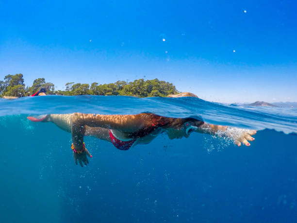 istock Woman floating on beach. 1170345848