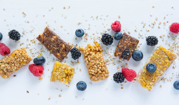istock Pattern with cereal bars and blueberries, blackberries and raspberries with oatmeal. Healthy snacks and breakfasts 1170345892