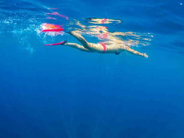 istock Woman floating on beach. 1170346787