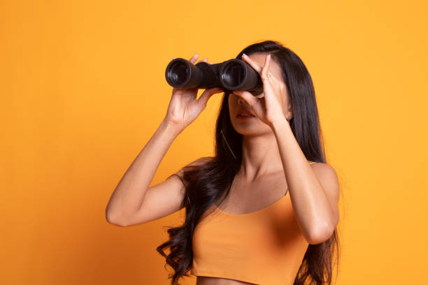 istock Young Asian woman with binoculars. 1170348255
