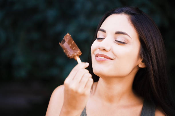 istock Beautiful woman eating ice-cream 1170348854
