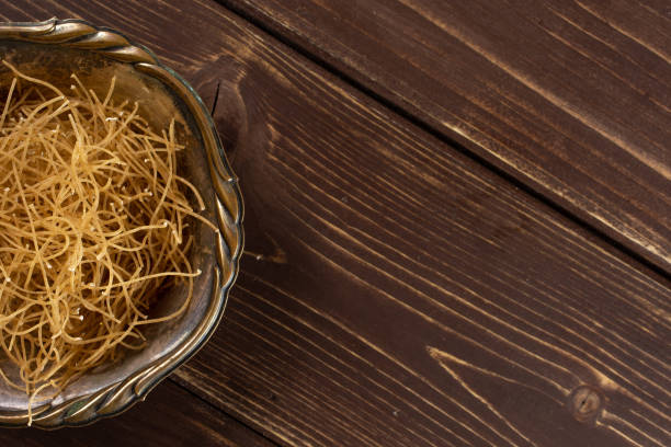 istock Raw thin noodles on brown wood 1170350436
