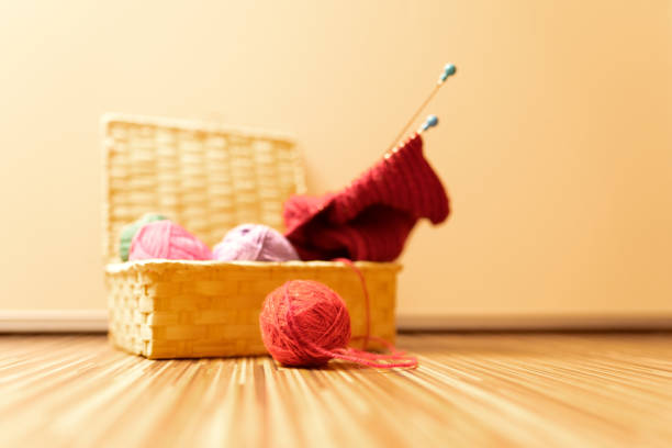Balls of wool in a basket for needlework. Knitting warm and cozy things.