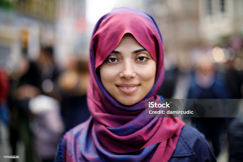 Portrait of smiling muslim woman outdoors Portrait Stock Photo
