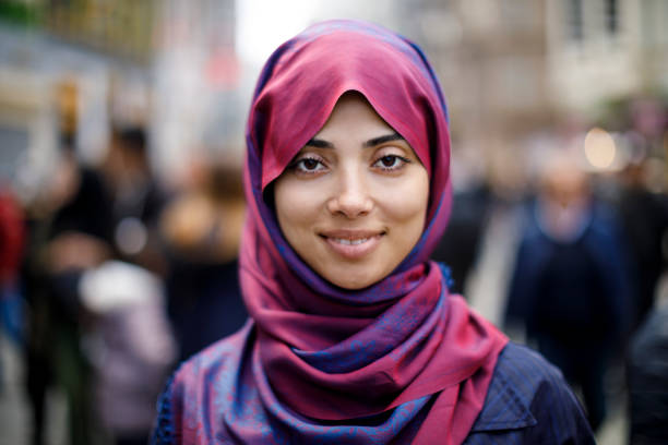 portrait of smiling muslim woman outdoors - holy city imagens e fotografias de stock