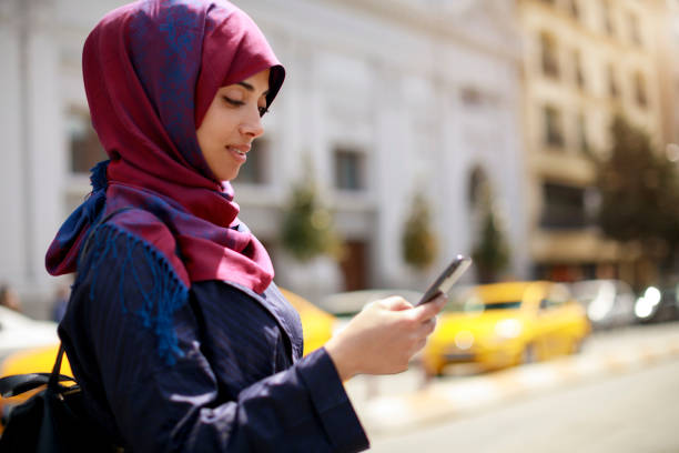 istock Young muslim woman using smartphone 1170357638