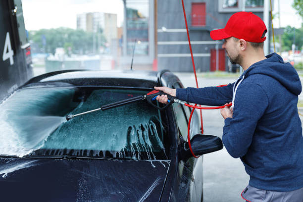 istock Car wash worker is washing client's car 1170357799