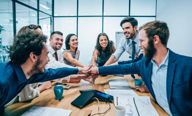 istock Business people stacking hands in conference room 1170359499