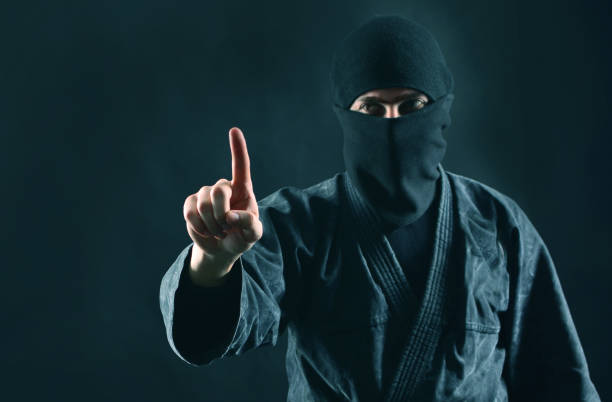 istock Man in black mask with pointing finger up. Copy space. Terrorism concept. 1170361867