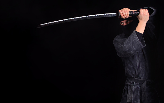 Ninja with katana close-up. Martial arts.