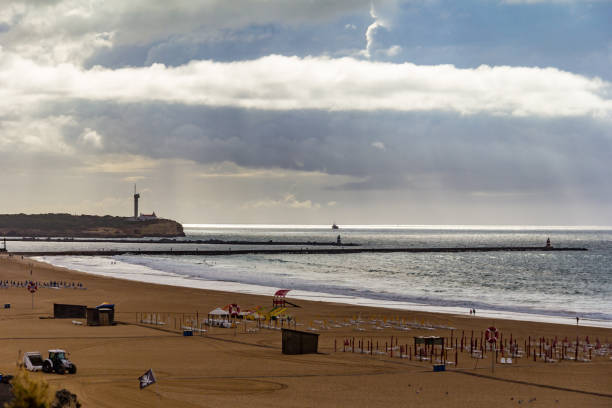 istock beach with seawalls and a lighthouse 1170362270