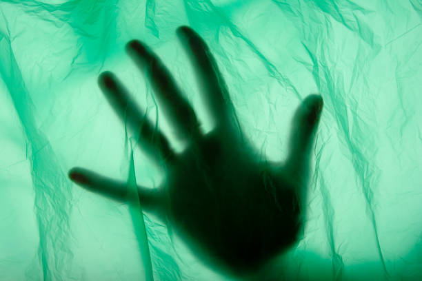Palms of unrecognizable person leaning on white canvas.