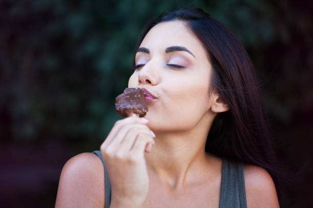 istock Beautiful woman eating ice-cream 1170367533