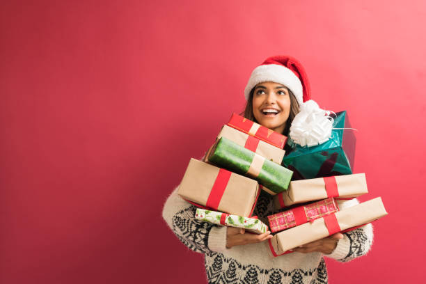 красивая дама с подарками во время празднования рождества - front view female isolated on red happiness стоковые фото и изображения