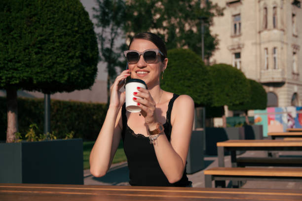 istock Girl drinking coffee to go outside 1170370798