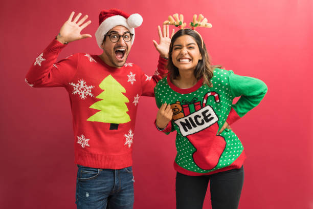 прекрасная пара в уродливых свитерах во время рождества - ugly sweater стоковые фото и изображения