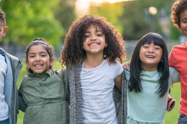 istock A group of smiling kids in the park 1170370979