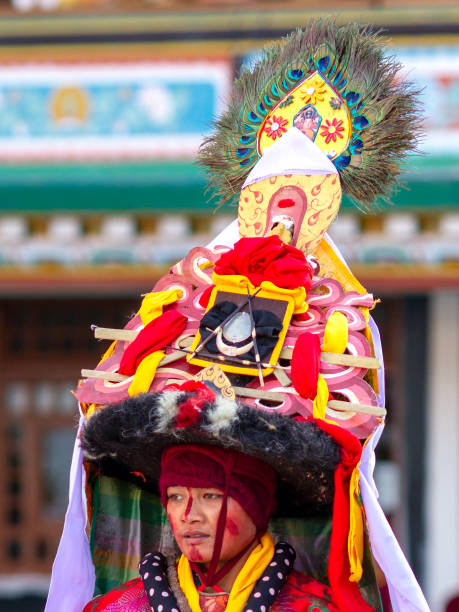 Close-up of lama in ritual costume and ornate hat performs a historical religious mystery Black Hat Dance of Tibetan Buddhism on the Cham Dance Festival Lingdum, Sikkim, India - December 23, 2011: Close-up of lama in ritual costume and ornate hat performs a historical religious mystery Black Hat Dance of Tibetan Buddhism on the Cham Dance Festival in Lingdum (Ranka) monastery cham mask stock pictures, royalty-free photos & images