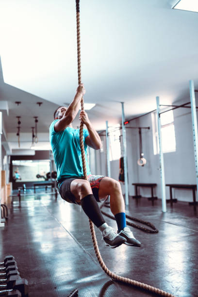 istock Male Climbing Rope In Gym 1170373131