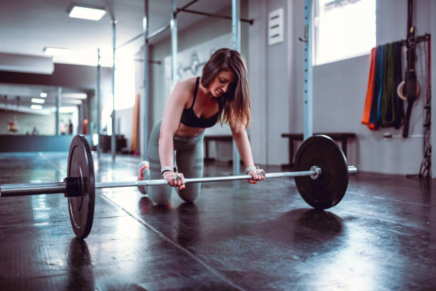 istock Female Getting Ready To Train With Barbell 1170376439