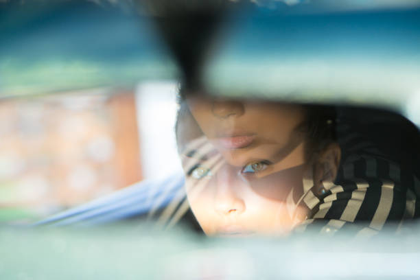 istock Beautiful woman driver reflecting in the rear view mirror. 1170377012