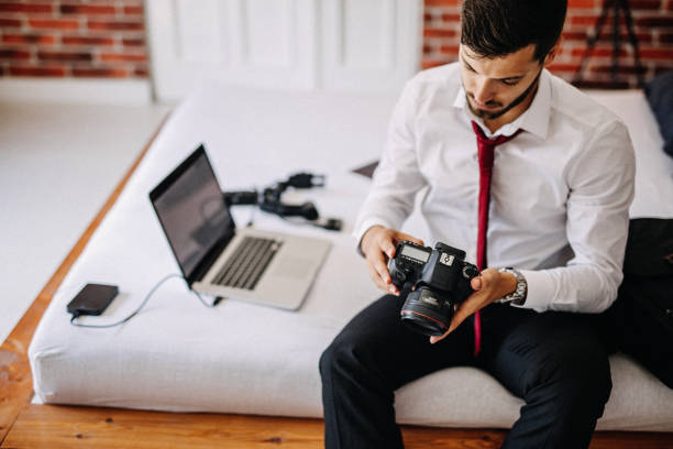 istock Photographer in hotel room 1170377623
