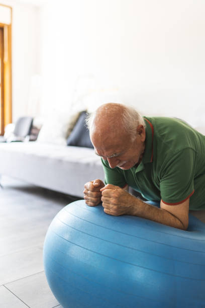 istock Active senior exercises on fitness ball 1170379505