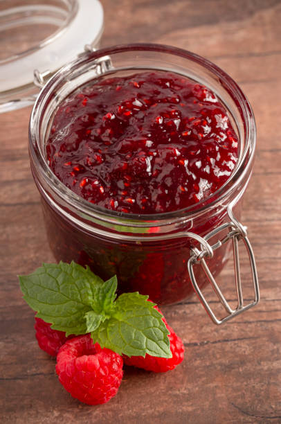 istock A Jar of Raspberry Jam on a Rustic Wooden Table 1170382741