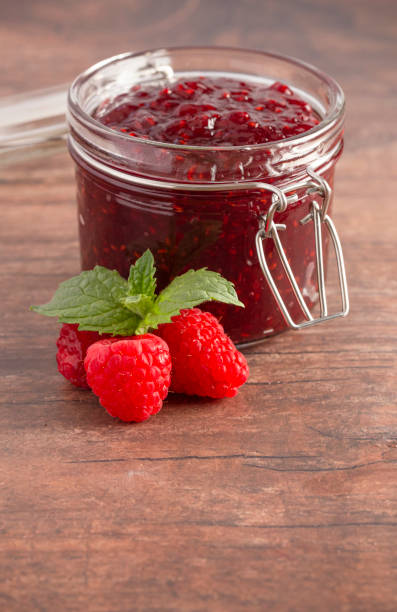 istock A Jar of Raspberry Jam on a Rustic Wooden Table 1170382839