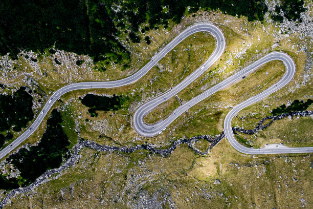 istock winding road in the mountains, aerial view 1170384098