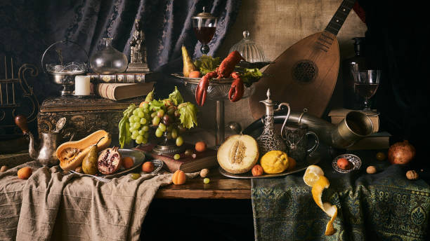 Still life with lobster A classic still-life in the Dutch old masters painting style with lobster, fruits on a silver, platter, silver carafe. old books , glass of wine, hunting horn and guitar lute . renaissance stock pictures, royalty-free photos & images