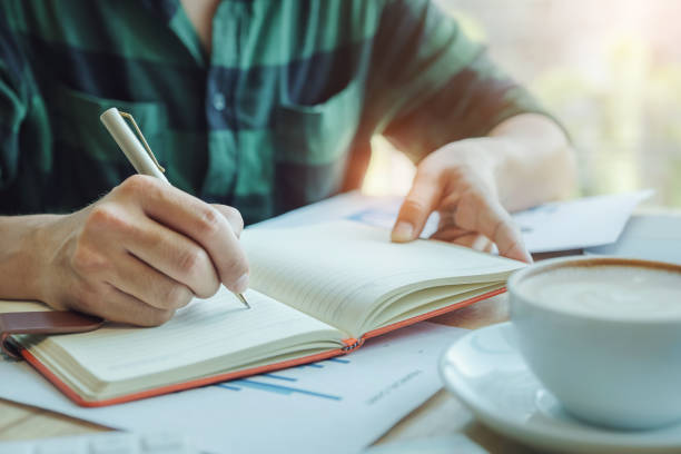 istock bookkeeper concept. The accountant using pen to note data for check the accuracy of the investment budget with using computer laptop and document data to analysis. 1170384872