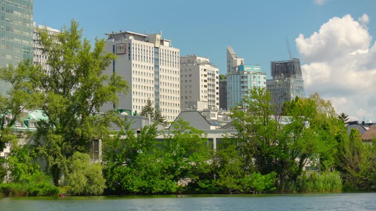 sunny day vienna city modern downtown park lake panorama 4k timelapse austria