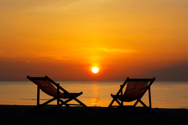 istock sunbed on the beach with sunrise background 1170388780
