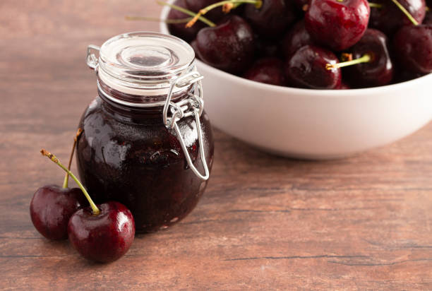 istock A Jar of Homemdae Cherry Jam on a Rustic Wooden Table 1170390072