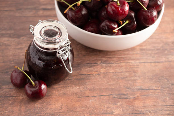 istock A Jar of Homemdae Cherry Jam on a Rustic Wooden Table 1170390158