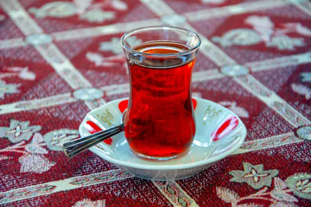 Photo of A cup of tea on traditional tablecloth