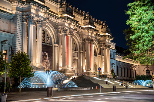 NEW YORK CITY, NY, USA - JUNE 17TH 2019 - Facade and fountain of the Metropolitan museum of art at night in NYC