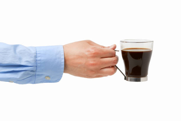 The woman's hands holding roasted coffee beans